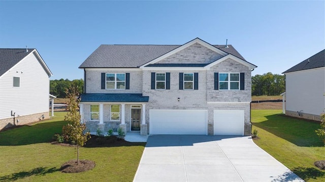 view of front of home with a garage and a front lawn