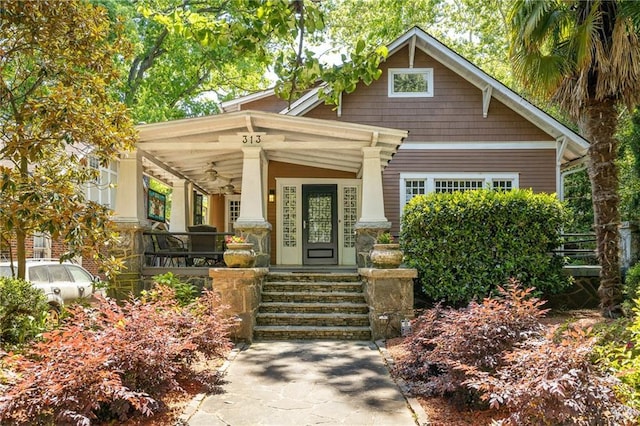 craftsman inspired home with covered porch and a ceiling fan