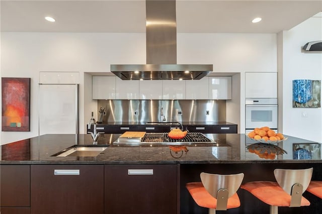 4835 Merlendale Ct, Atlanta, GA 30327 - kitchen featuring range hood, oven, a sink, modern cabinets, and stainless steel gas cooktop