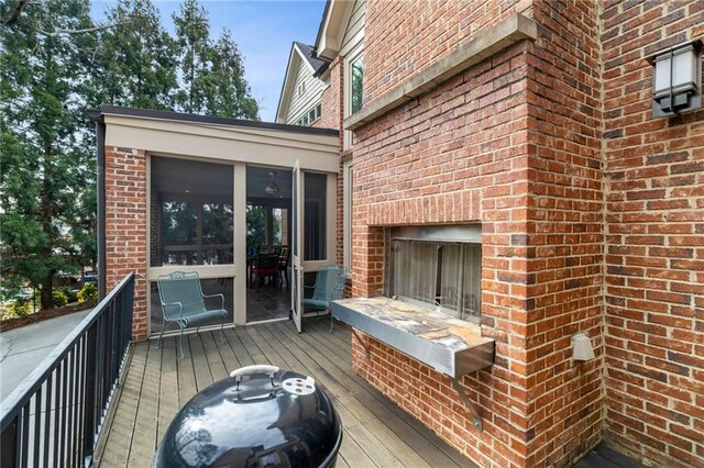 4835 Merlendale Ct, Atlanta, GA 30327 - deck featuring a sunroom and an outdoor brick fireplace