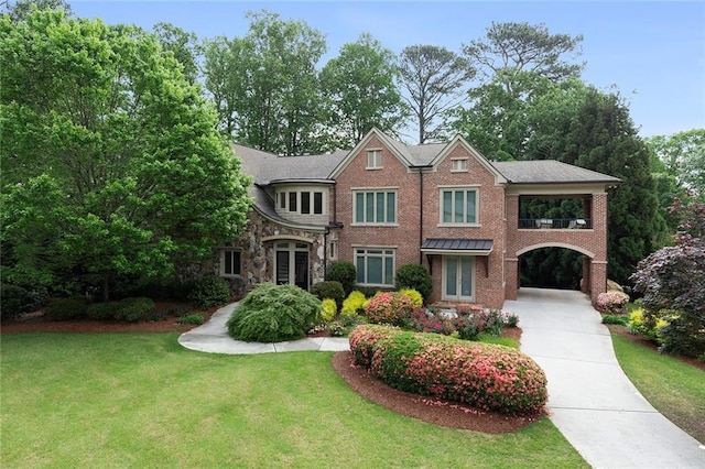 4835 Merlendale Ct, Atlanta, GA 30327 - view of front facade with french doors, a front lawn, brick siding, and concrete driveway