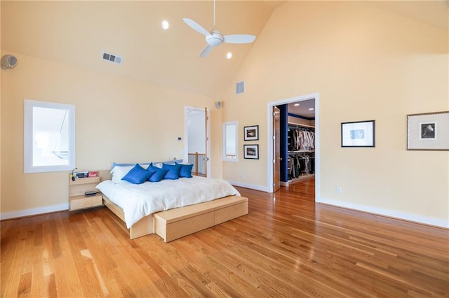 4835 Merlendale Ct, Atlanta, GA 30327 - bedroom with high vaulted ceiling, a walk in closet, light wood finished floors, and visible vents