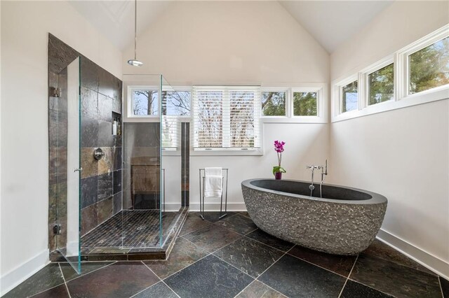 4835 Merlendale Ct, Atlanta, GA 30327 - full bathroom with baseboards, a soaking tub, vaulted ceiling, and a stall shower