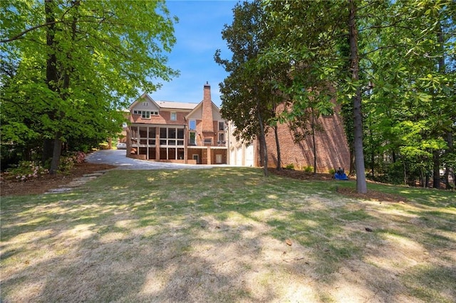4835 Merlendale Ct, Atlanta, GA 30327 - view of yard with an attached garage and a sunroom