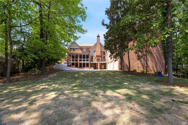 4835 Merlendale Ct, Atlanta, GA 30327 - view of yard featuring an attached garage and a sunroom