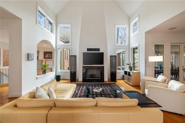 4835 Merlendale Ct, Atlanta, GA 30327 - living room with high vaulted ceiling, a wealth of natural light, wood finished floors, and a large fireplace