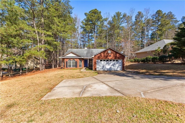 view of front of home with brick siding, a garage, a front lawn, and driveway