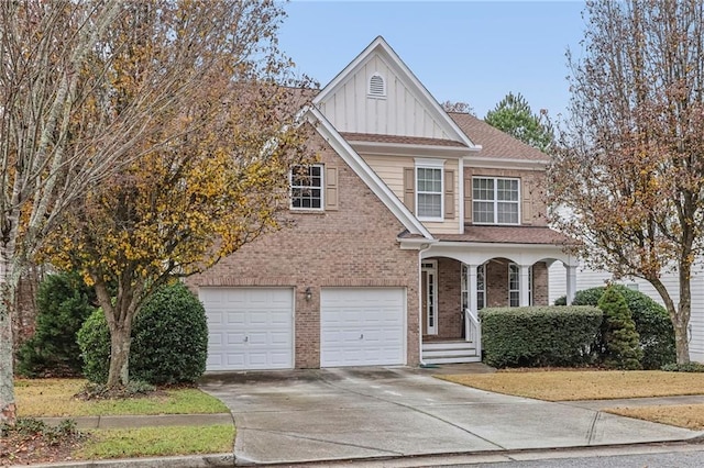 view of front of home featuring driveway, a garage, covered porch, board and batten siding, and brick siding