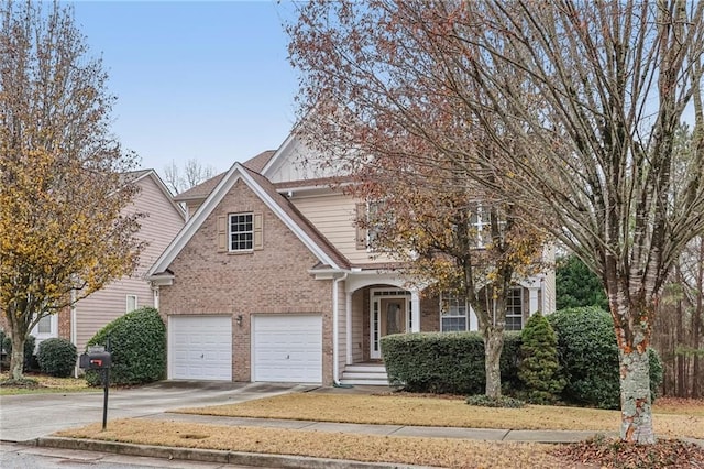 view of front facade featuring a garage, concrete driveway, and brick siding