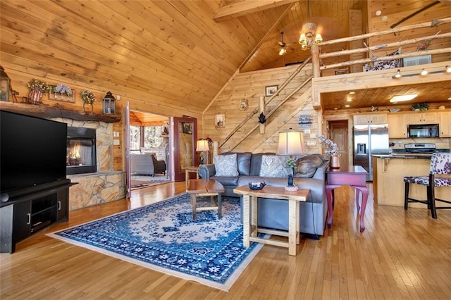 living room featuring beamed ceiling, high vaulted ceiling, hardwood / wood-style floors, wooden ceiling, and wood walls