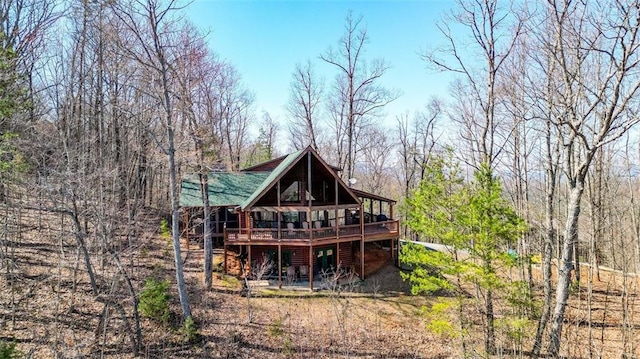 back of property featuring a deck and faux log siding