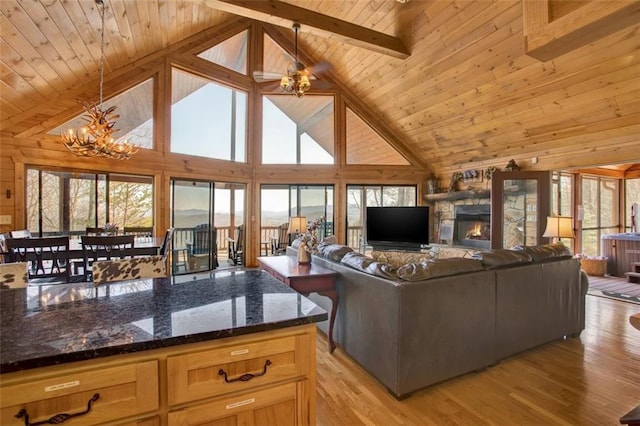 living room with light wood-style floors, an inviting chandelier, wooden ceiling, and a fireplace