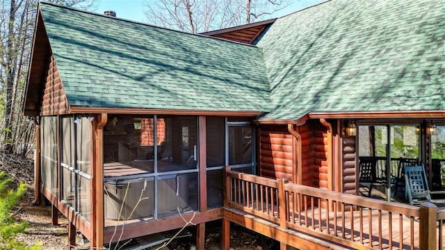 wooden deck featuring a sunroom