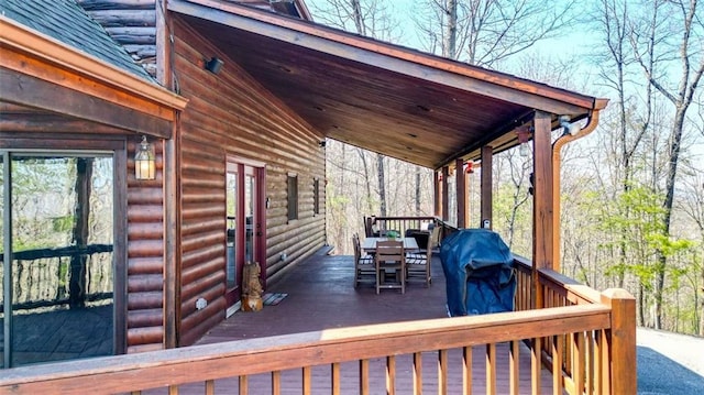 wooden deck featuring a grill