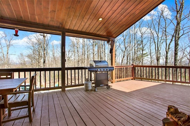 wooden terrace with a grill