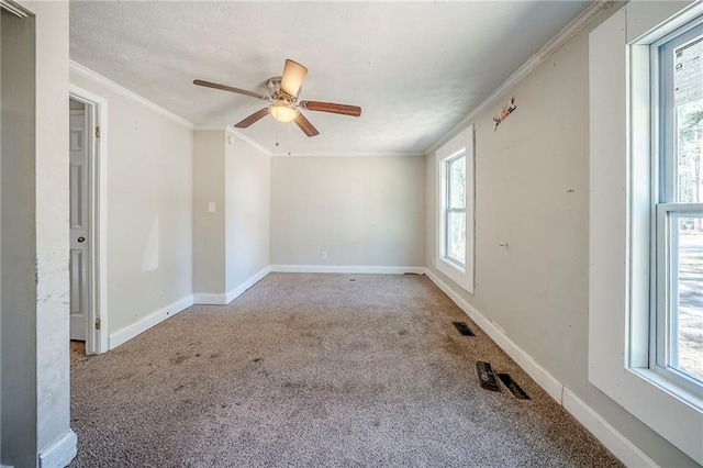 unfurnished room featuring carpet, ornamental molding, and baseboards