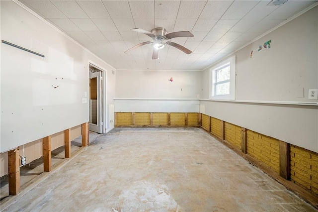 empty room with concrete flooring, crown molding, and a ceiling fan