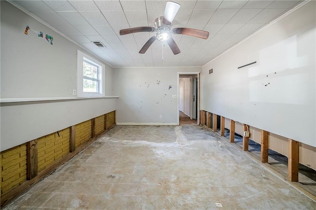 spare room featuring visible vents, crown molding, and unfinished concrete floors