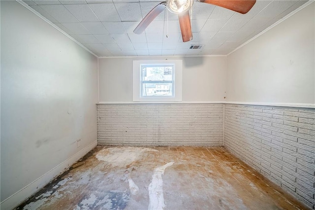 unfurnished room with brick wall, a ceiling fan, visible vents, unfinished concrete floors, and crown molding