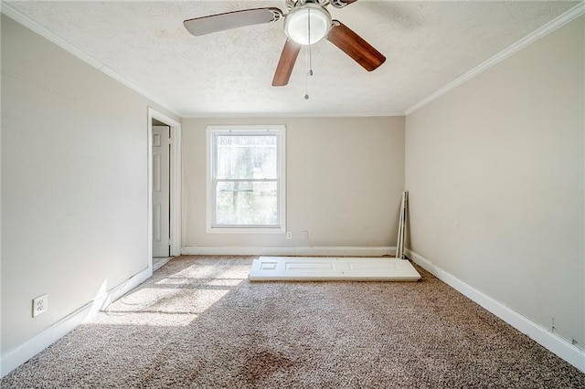 empty room with baseboards, carpet, ornamental molding, and a textured ceiling