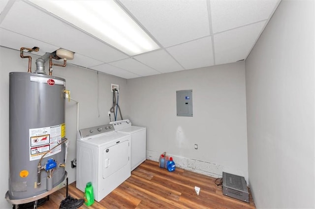 clothes washing area with water heater, washing machine and dryer, electric panel, and wood finished floors