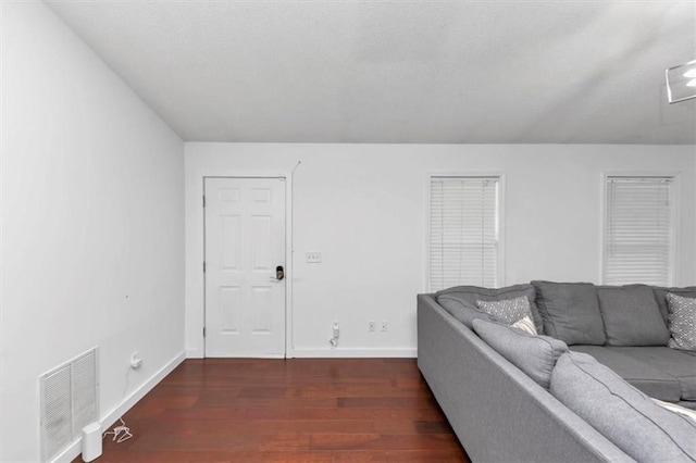 living room with dark wood-style floors and baseboards