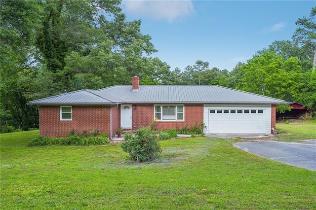 ranch-style house featuring driveway, an attached garage, metal roof, and brick siding