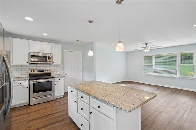 kitchen featuring stainless steel appliances, decorative backsplash, white cabinetry, dark wood finished floors, and recessed lighting