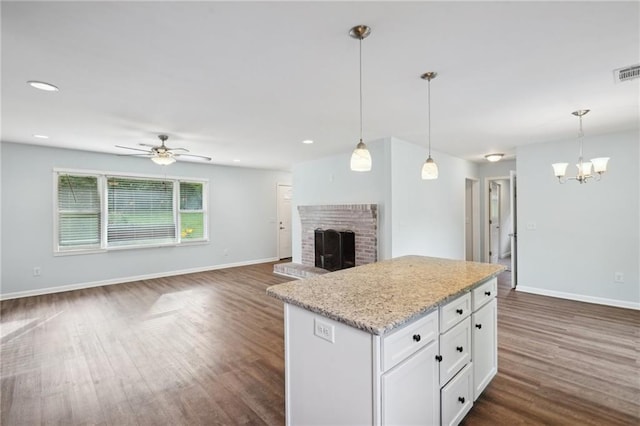 kitchen featuring dark wood-type flooring, baseboards, white cabinets, and recessed lighting