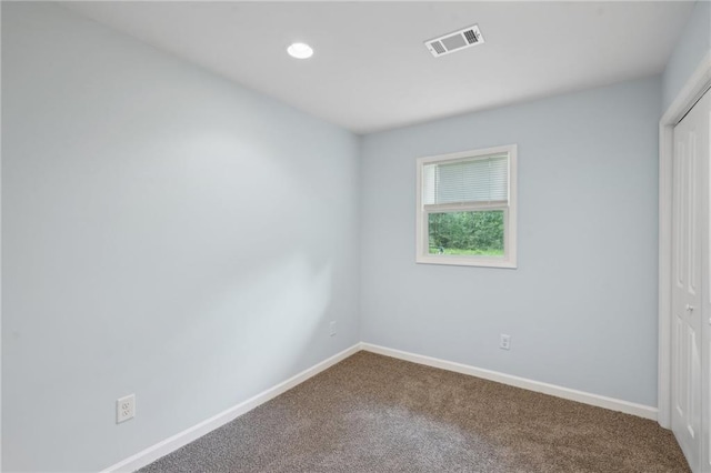 carpeted spare room featuring baseboards and recessed lighting