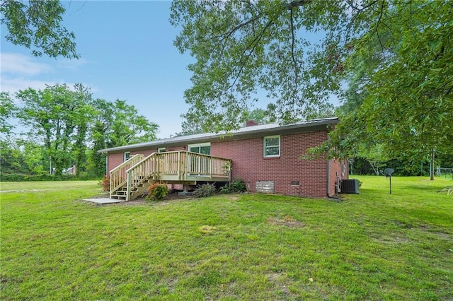 rear view of house with a wooden deck, crawl space, cooling unit, and a lawn