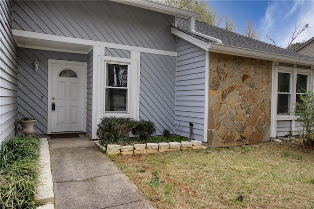 property entrance featuring stone siding