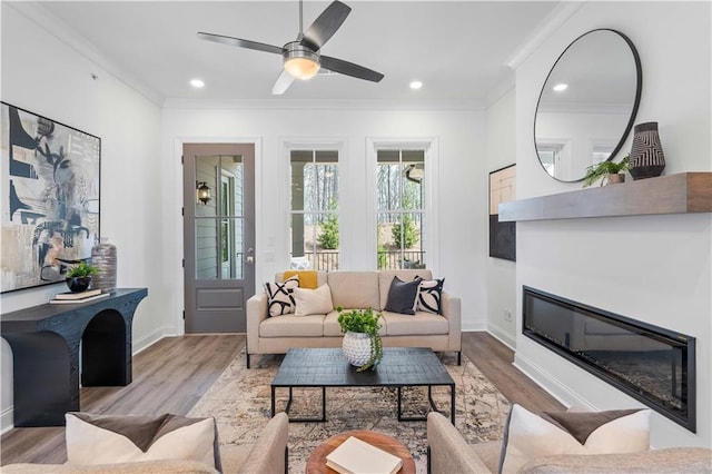 4933 Sudbrook Way Unit 230, Peachtree Corners, GA 30092 - living room with a glass covered fireplace, ornamental molding, light wood-style floors, a ceiling fan, and baseboards