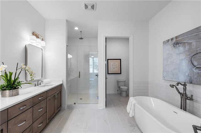 4933 Sudbrook Way Unit 230, Peachtree Corners, GA 30092 - full bathroom featuring a stall shower, double vanity, a freestanding bath, toilet, and marble look tile flooring