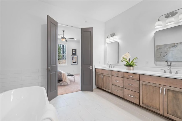 4933 Sudbrook Way Unit 230, Peachtree Corners, GA 30092 - ensuite bathroom with double vanity, a freestanding tub, marble finish floors, and ceiling fan