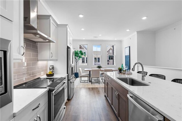 4933 Sudbrook Way Unit 230, Peachtree Corners, GA 30092 - kitchen with appliances with stainless steel finishes, wall chimney exhaust hood, a sink, dark wood-style floors, and light stone countertops