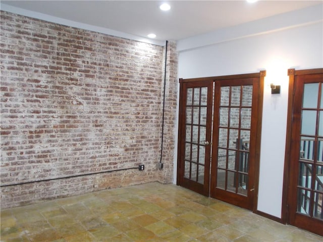 interior space with brick wall and french doors