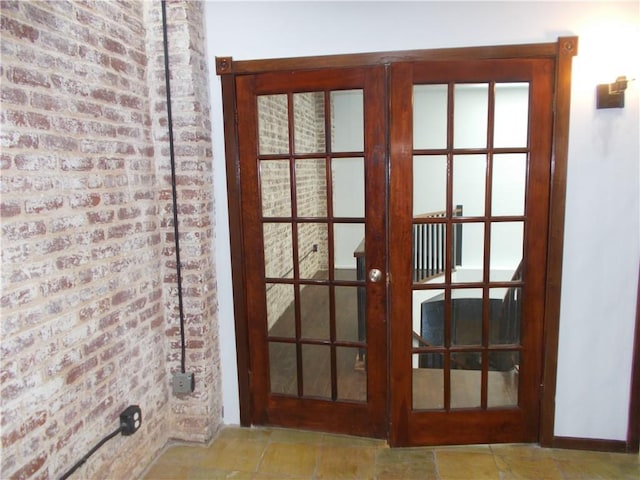 doorway featuring brick wall