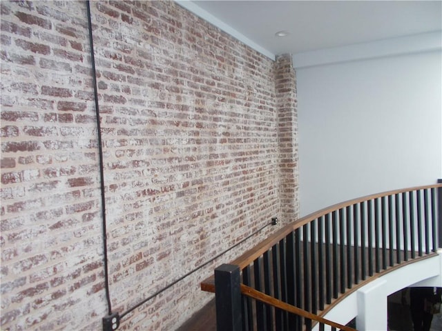 hall featuring brick wall