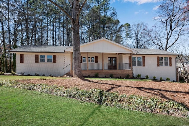 ranch-style home with brick siding, a porch, and a front yard