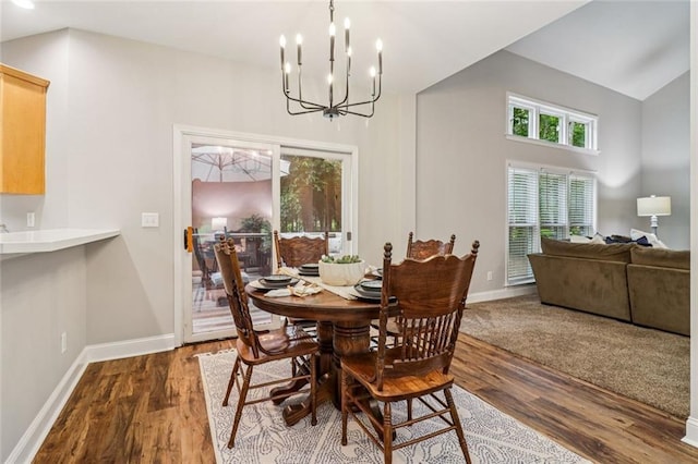 1006 Amberton Ln, Powder Springs, GA 30127 - dining room featuring a chandelier, dark wood-style floors, and baseboards