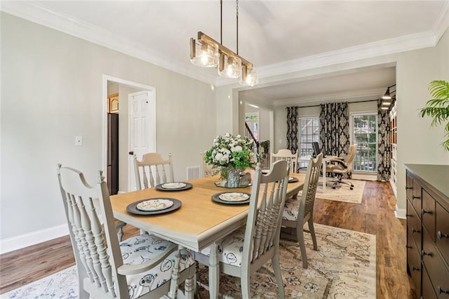 1006 Amberton Ln, Powder Springs, GA 30127 - dining room with wood finished floors, ornamental molding, and baseboards