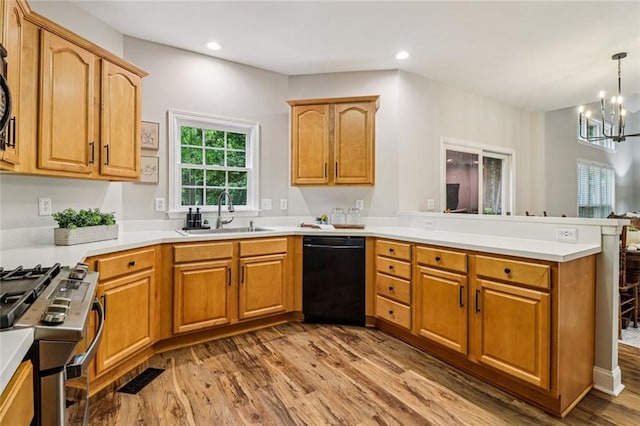 1006 Amberton Ln, Powder Springs, GA 30127 - kitchen featuring dishwasher, a sink, stainless steel gas range oven, a peninsula, and a chandelier