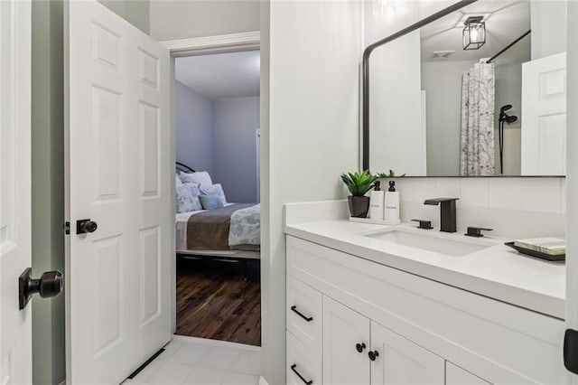 1006 Amberton Ln, Powder Springs, GA 30127 - bathroom with vanity, connected bathroom, and curtained shower