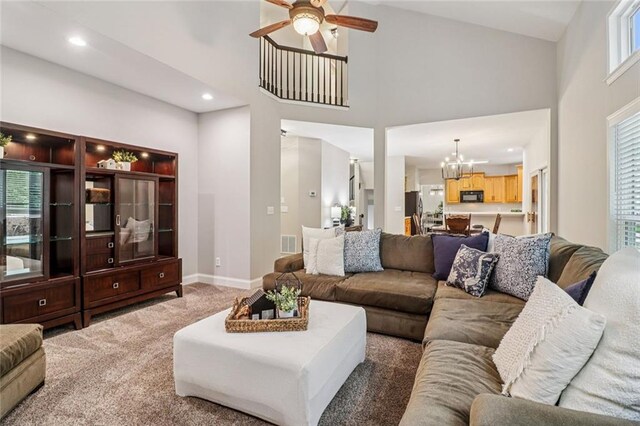 1006 Amberton Ln, Powder Springs, GA 30127 - living area with a chandelier, ceiling fan, a high ceiling, carpet, and baseboards