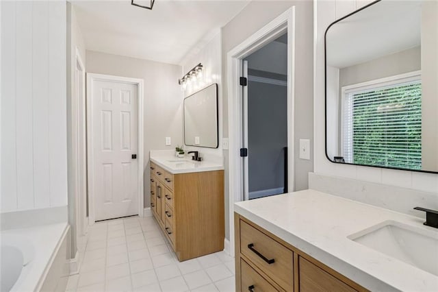 1006 Amberton Ln, Powder Springs, GA 30127 - full bathroom featuring two vanities, a bathtub, and tile patterned floors