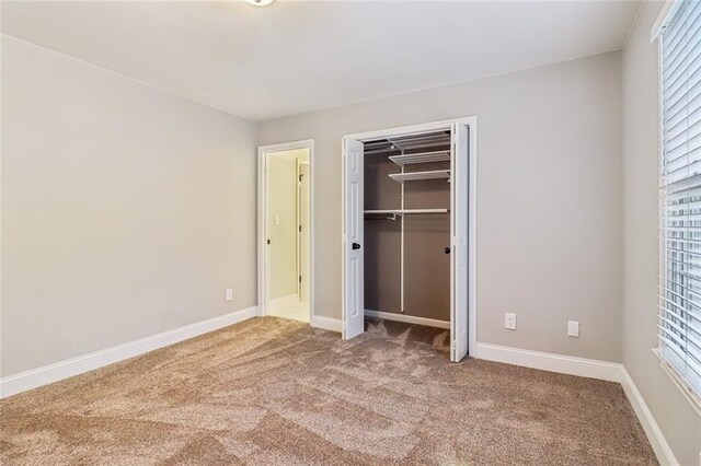 1006 Amberton Ln, Powder Springs, GA 30127 - unfurnished bedroom with carpet flooring, baseboards, and a closet