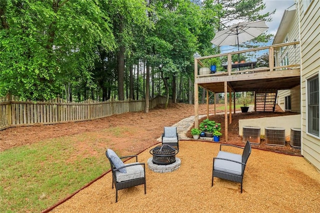 1006 Amberton Ln, Powder Springs, GA 30127 - view of yard featuring stairs, a wooden deck, an outdoor fire pit, and central AC unit