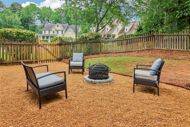 1006 Amberton Ln, Powder Springs, GA 30127 - fenced backyard with an outdoor fire pit and a residential view
