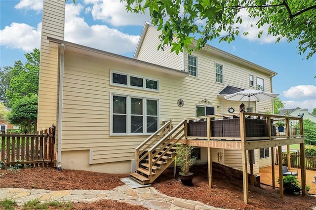 1006 Amberton Ln, Powder Springs, GA 30127 - back of property featuring a wooden deck, a chimney, and stairway